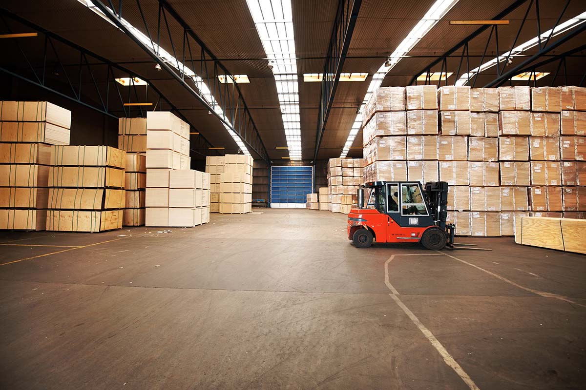 A warehouse filled with boxes and a forklift.