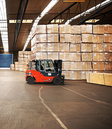 A forklift is parked in front of boxes.