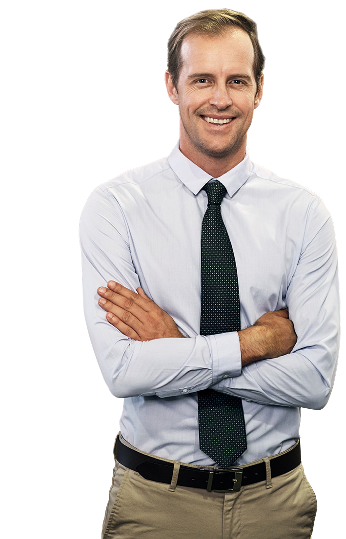 A man in dress clothes and tie with his arms crossed.