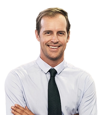 A man in a white shirt and tie smiling.