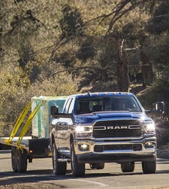 A truck pulling a trailer on the road